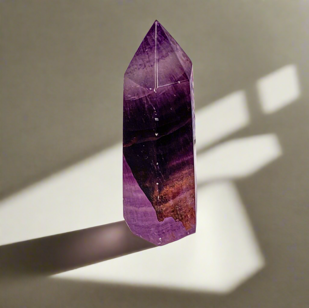 Deep purple amethyst point with variation in color 