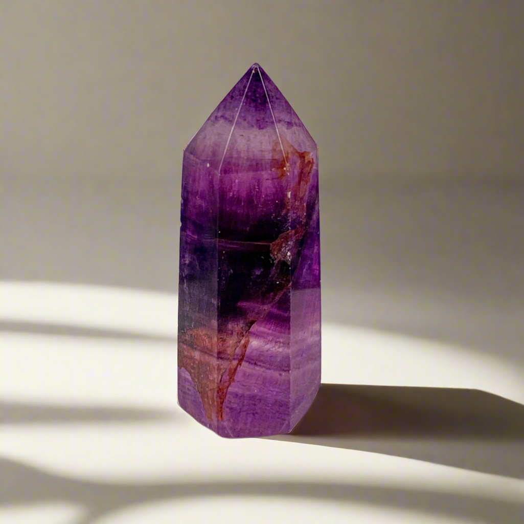 Deep purple amethyst point with rust swirl through out 