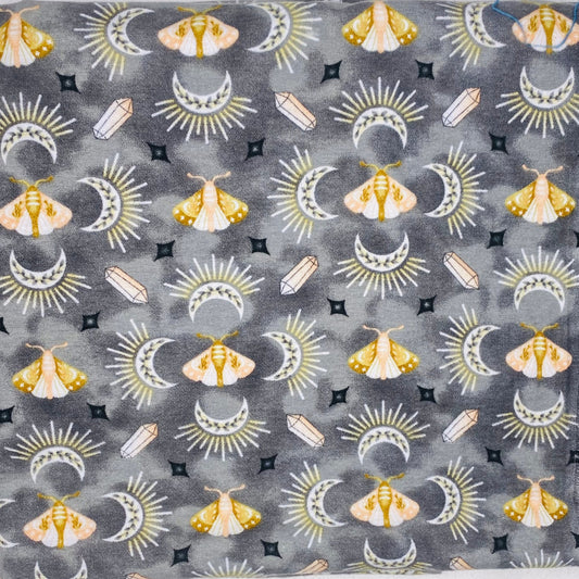 Golden moths with crescent moons and crystal on grey background 