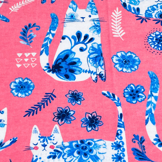 Porcelain blue and white cats with floral pattern on pink background 