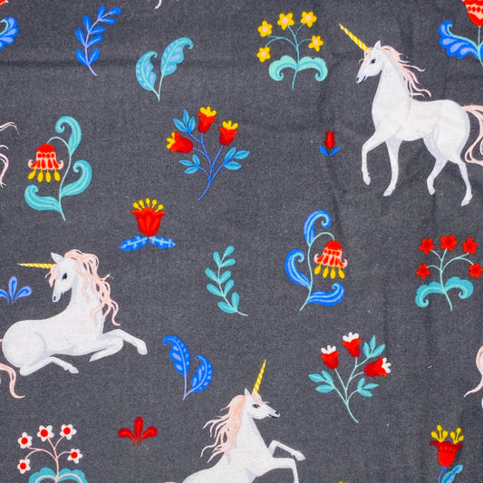 White Unicorn with light spink hair on grey background with red and yellow flowers and blue folage 